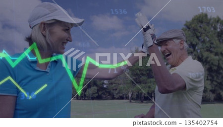 High-fiving couple on golf course fairway wearing caps and golf gloves, with neon green line graph 135402754