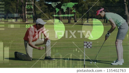 Standing female golfer aligning putter at putting green, with male kneeling, pie charts overlaying 135402763
