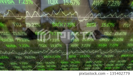 Displaying single golf ball sitting on T-shaped tee over well-mown grass, with stock ticker overlay 135402779