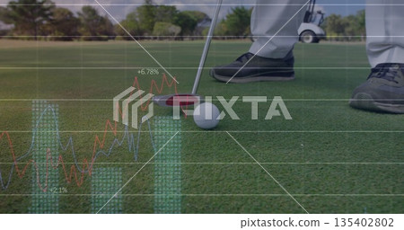 Aligning golfer wearing grey trousers placing putter head behind golf ball on green with overlays 135402802
