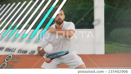 Tennis player in white holding racket preparing return on clay court with bar overlay, blurred ball 135402906