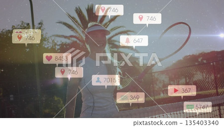 Holding racket, wearing visor, tennis player standing by net on court, social media icons floating Holding racket, wearing visor, tennis player standing by net on court, social media icons floating 135403340