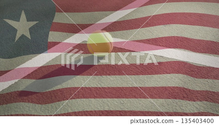 Resting yellow tennis ball beside white boundary line on red court, flag overlay, copy space 135403400