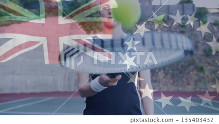 Female tennis player wearing black top swinging racket at outdoor court, with ball and UK or EU flag Female tennis player wearing black top swinging racket at outdoor court, with ball and UK or EU flag 135403432