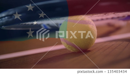 Hovering tennis racket strings pressing down on tennis ball on hard court, with flag overlay Hovering tennis racket strings pressing down on tennis ball on hard court, with flag overlay 135403434