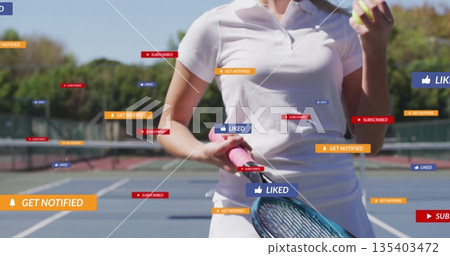 Tennis player wearing white kit holding pink racket with ball on court, with notification banners 135403472