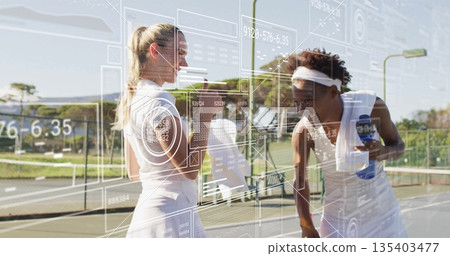Sharing fist bump by two tennis players at tennis net outdoors, with water bottles, data overlay Sharing fist bump by two tennis players at tennis net outdoors, with water bottles, data overlay 135403477