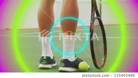 Displaying lower legs wearing socks, navy shoes on tennis court, with racket, ball and neon rings Displaying lower legs wearing socks, navy shoes on tennis court, with racket, ball and neon rings 135403499