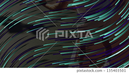 Standing man wearing red top and light trousers in gallery, with teal purple streaks, copy space 135403501