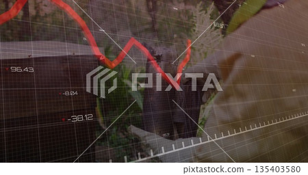 Standing senior executive in suit gazing amid foliage, with red trend line, numeric grid overlay 135403580