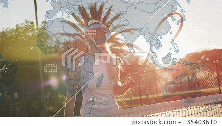 Standing tennis player in white dress holding racket near net on court, with world map overlays 135403610