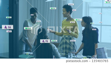 Four women wearing business attire analyzing digital overlays at conference table, with laptop 135403765