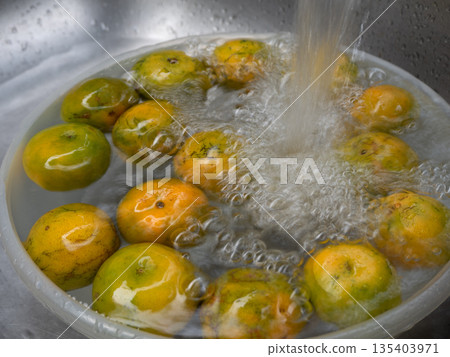 The Orange fruit soke and wash in the water 135403971