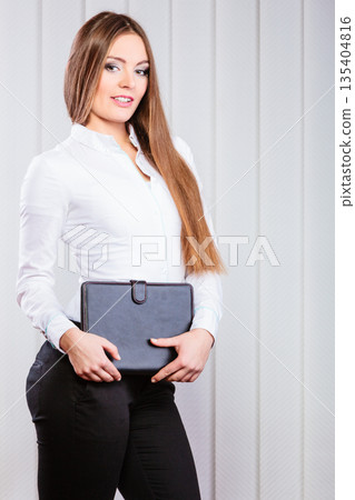Young woman office worker hold case with files. Young woman office worker hold case with files. 135404816