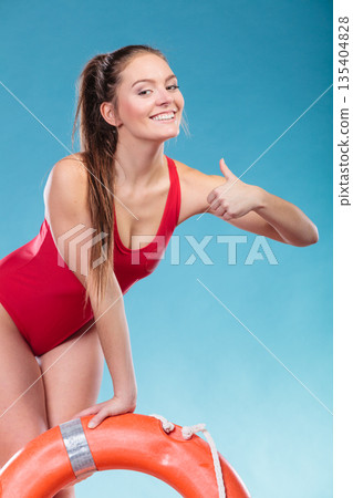 Lifeguard woman on duty with ring buoy lifebuoy. Lifeguard woman on duty with ring buoy lifebuoy. 135404828
