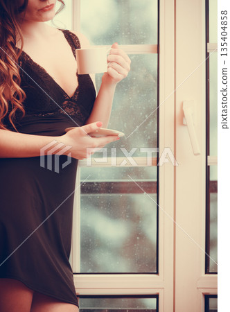 Sensual woman drinking hot coffee beverage at home 135404858