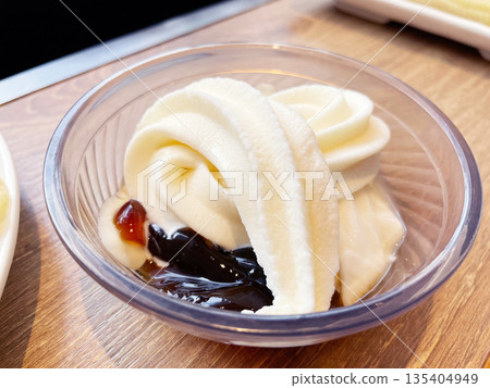 Coffee jelly topped with soft serve ice cream - a classic coffee shop dessert. Coffee jelly topped with soft serve ice cream - a classic coffee shop dessert. 135404949