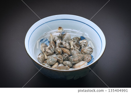 蛤蜊在裝有鹽水的容器中進行除沙處理 135404991