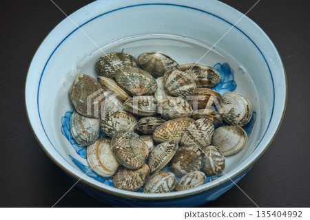 蛤蜊在裝有鹽水的容器中進行除沙處理 135404992