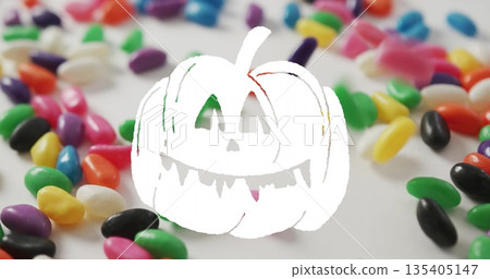 Jack-o-lantern image over colorful jelly beans scattered on white background Jack-o-lantern image over colorful jelly beans scattered on white background 135405147