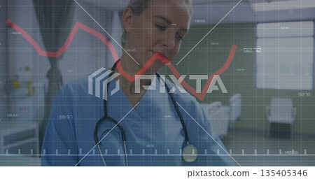 Focusing medical professional with stethoscope reviewing data in clinic hallway, with graph overlay Focusing medical professional with stethoscope reviewing data in clinic hallway, with graph overlay 135405346