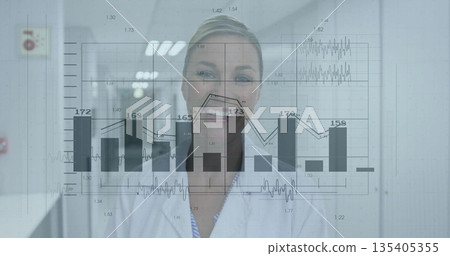 Woman wearing lab coat analyzing data in medical corridor, with digital bar and line charts 135405355