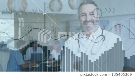 Doctor wearing lab coat, stethoscope leading meeting at conference table, with laptops and charts 135405369