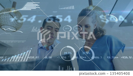 Reviewing professionals in suit jacket, blouse leaning over laptop at office with floating charts 135405408