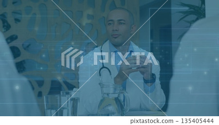 Joining doctor wearing lab coat with stethoscope consulting during medical meeting, with paperwork Joining doctor wearing lab coat with stethoscope consulting during medical meeting, with paperwork 135405444
