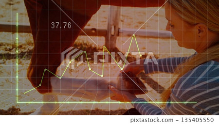 Cleaning horse hoof, woman in striped shirt kneeling, using hoof pick in corral with wooden fence Cleaning horse hoof, woman in striped shirt kneeling, using hoof pick in corral with wooden fence 135405550