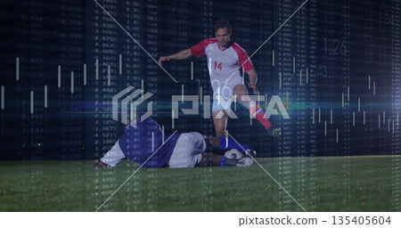 Dribbling player wearing red jersey, cleats pushing ball on grass field under lights, data overlay Dribbling player wearing red jersey, cleats pushing ball on grass field under lights, data overlay 135405604