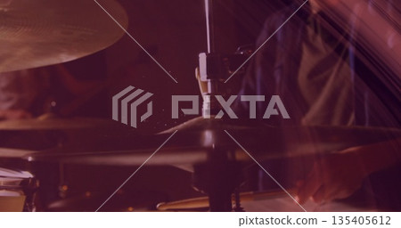 Striking drummer's hands hitting metal cymbal at stage rehearsal, with wooden sticks flaking dust Striking drummer's hands hitting metal cymbal at stage rehearsal, with wooden sticks flaking dust 135405612