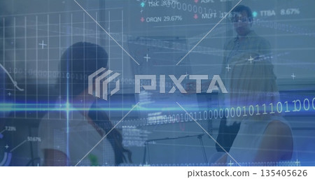 Pointing presenter wearing green shirt explaining charts in meeting room with stock ticker overlays 135405626