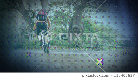 Riding cyclist pedaling through forest trail, with mountain bike, helmet, backpack, glitch effect 135405637