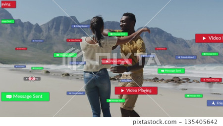 Couple dancing and embracing at sandy shoreline, with floating green, red and blue notifications 135405642