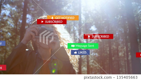 Capturing photographer framing scene in sunlit pine forest, with vintage camera and floating alerts Capturing photographer framing scene in sunlit pine forest, with vintage camera and floating alerts 135405663