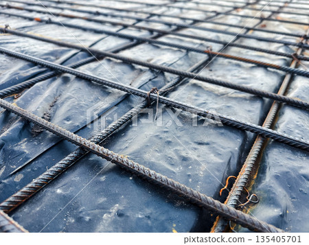 Close-up of steel rebar grid on construction site. Close-up of steel rebar grid on construction site. 135405701