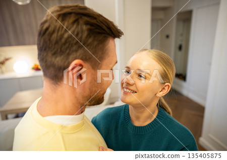 Happy married couple man and woman smiling at each other, enjoying peace and love in relationships. Happy married couple man and woman smiling at each other, enjoying peace and love in relationships. 135405875