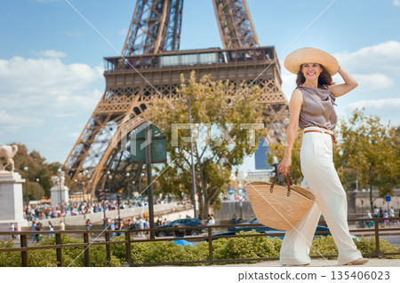 Elegant Solo Traveler Walking by Eiffel Tower 135406023