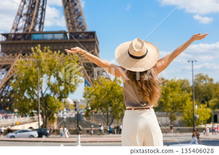 Joyful Woman with Outstretched Arms at Eiffel Tower Joyful Woman with Outstretched Arms at Eiffel Tower 135406028