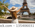 Joyful Woman Embracing Paris View with Eiffel Tower 135406031