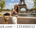 Smiling Woman with Straw Bag Enjoying Sunny Paris 135406032