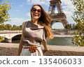 Elegant Woman Posing with Eiffel Tower in Paris 135406033