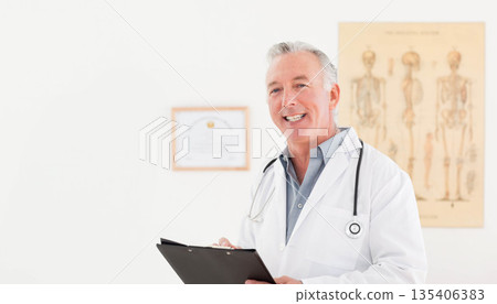 Senior White male doctor holding clipboard and stethoscope in clinic with anatomy chart, copy space Senior White male doctor holding clipboard and stethoscope in clinic with anatomy chart, copy space 135406383