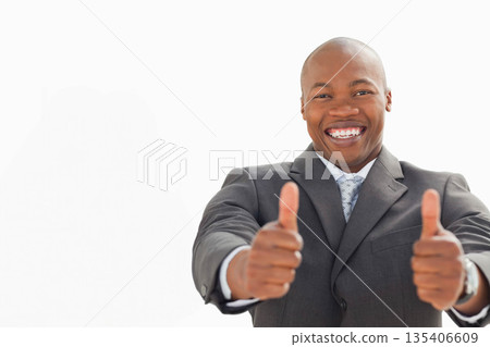 African American man posing with thumbs-up in studio, wearing grey suit jacket and patterned tie African American man posing with thumbs-up in studio, wearing grey suit jacket and patterned tie 135406609