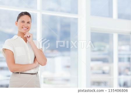 Female wearing casual attire smiling resting chin by office windows with skyline blur, copy space Female wearing casual attire smiling resting chin by office windows with skyline blur, copy space 135406806