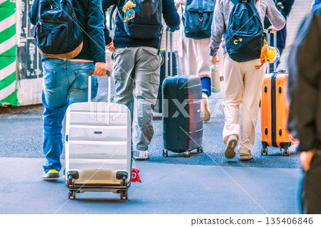 Tokyo cityscape suitcases in Japan. Foreign tourists heading to the intersection at Miyamasuzakashita from Shibuya Station on the Ginza Line. 135406846