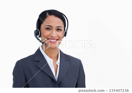 Asian woman answering customer calls in studio wearing dark gray blazer and headset microphone Asian woman answering customer calls in studio wearing dark gray blazer and headset microphone 135407236