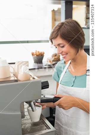 Female barista holding portafilter and pouring espresso into ceramic cup at coffee shop counter Female barista holding portafilter and pouring espresso into ceramic cup at coffee shop counter 135407314