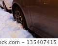 Car Tire Stuck in Deep Winter Snow 135407415